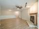 Spacious living area with a fireplace, ceiling fan, and modern flooring throughout at 3205 Canyon Point Cir, Roswell, GA 30076