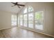 Inviting living room with high ceilings, expansive windows, and a ceiling fan for comfort at 3205 Canyon Point Cir, Roswell, GA 30076