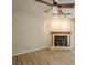 Cozy living room with a fireplace, ceiling fan, and beautiful hardwood floors at 3205 Canyon Point Cir, Roswell, GA 30076