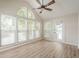 Bright sunroom with high ceilings, expansive windows, and a ceiling fan for comfort at 3205 Canyon Point Cir, Roswell, GA 30076