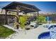 Backyard with covered patio, waterfall feature and in-ground pool at 6048 Prodigy Ln, Locust Grove, GA 30248