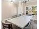 Spacious dining area illuminated by chandelier and natural light, with seating for eight at 6048 Prodigy Ln, Locust Grove, GA 30248