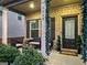 Charming front porch with seating area and festive holiday decor at 6048 Prodigy Ln, Locust Grove, GA 30248