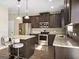 Modern kitchen with stainless steel appliances, granite countertops, and a center island with bar stool seating at 6048 Prodigy Ln, Locust Grove, GA 30248