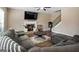 Comfortable living room features a fireplace, ceiling fan, and a large sofa for relaxing at 6048 Prodigy Ln, Locust Grove, GA 30248