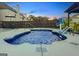 Backyard pool with a waterfall feature and sunning area at 6048 Prodigy Ln, Locust Grove, GA 30248