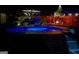 Inviting outdoor pool beautifully illuminated at night, perfect for relaxation and entertainment at 6048 Prodigy Ln, Locust Grove, GA 30248