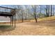 A spacious backyard featuring a wood fence, deck and dry grass at 2275 Perch Sw Way, Marietta, GA 30008