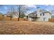 A spacious backyard with a wooden deck, wooden fence, and dry grass at 2275 Perch Sw Way, Marietta, GA 30008