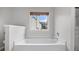 Clean white bathtub with a window, perfect for a relaxing soak with natural light at 2275 Perch Sw Way, Marietta, GA 30008