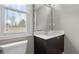 Bathroom with a gray vanity, decorative mirror, and window providing natural light at 2275 Perch Sw Way, Marietta, GA 30008