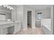 Modern bathroom featuring vanity with large mirror and walk-in closet at 2275 Perch Sw Way, Marietta, GA 30008