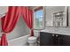 Bathroom featuring a shower/tub combination, red curtains, and a gray vanity at 2275 Perch Sw Way, Marietta, GA 30008