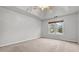 Cozy bedroom with plush carpeting, a ceiling fan, and a window overlooking the front yard at 2275 Perch Sw Way, Marietta, GA 30008