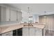 Bright kitchen features stainless steel sink, white cabinetry, and modern lighting fixtures at 2275 Perch Sw Way, Marietta, GA 30008