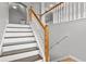 Well-lit staircase with white banisters, leading to the upper level of the home at 2275 Perch Sw Way, Marietta, GA 30008