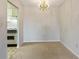 Empty dining room with chandelier and view into the adjacent kitchen at 300 Johnson Ferry Ne Rd # B401, Atlanta, GA 30328