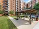 Community outdoor poolside seating area with a pergola and views of the condo building at 300 Johnson Ferry Ne Rd # B401, Atlanta, GA 30328