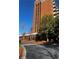 Exterior shot of the brick condo building with trees, lawn, and a blacktop drive at 300 Johnson Ferry Ne Rd # B401, Atlanta, GA 30328