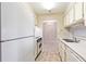 Kitchen with white appliances, countertops, cabinets, and view into dining area at 300 Johnson Ferry Ne Rd # B401, Atlanta, GA 30328