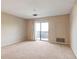 Bright living room featuring neutral carpet, walls and a sliding door to the balcony at 300 Johnson Ferry Ne Rd # B401, Atlanta, GA 30328