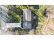 An aerial view showing the property and landscaped yard with mature trees and proximity to the road at 1903 Olde Village Run, Dunwoody, GA 30338