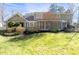 Expansive backyard with a lush lawn, mature trees, and a charming white fence at 1903 Olde Village Run, Dunwoody, GA 30338