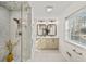 Bathroom featuring glass shower, double vanity, marble tile, and modern fixtures at 1903 Olde Village Run, Dunwoody, GA 30338