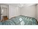 Well-lit bedroom features a ceiling fan, double closet, and doorway leading to another room at 1903 Olde Village Run, Dunwoody, GA 30338