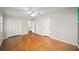 Well-lit bedroom featuring hardwood floors, neutral walls, and a ceiling fan at 1903 Olde Village Run, Dunwoody, GA 30338