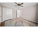 Bedroom with decorative rug, ceiling fan, and large closet at 1903 Olde Village Run, Dunwoody, GA 30338