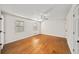 Bright bedroom with hardwood floors, ceiling fan, and natural light from two windows at 1903 Olde Village Run, Dunwoody, GA 30338