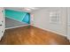 Spacious bedroom featuring hardwood floors and painted accent wall at 1903 Olde Village Run, Dunwoody, GA 30338