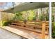 A wooden gathering space features a shaded picnic table, offering a relaxing place for residents at 1903 Olde Village Run, Dunwoody, GA 30338