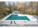 Large fenced community pool with parking lot in the foreground and wooded area behind the pool at 1903 Olde Village Run, Dunwoody, GA 30338