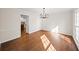 Sunlit dining room featuring hardwood floors and a modern chandelier fixture at 1903 Olde Village Run, Dunwoody, GA 30338