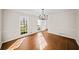 Bright dining room featuring hardwood floors and large windows offering natural light at 1903 Olde Village Run, Dunwoody, GA 30338