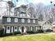 Beautiful two-story home with a well-maintained lawn, complemented by mature trees at 1903 Olde Village Run, Dunwoody, GA 30338