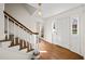 Bright foyer featuring hardwood floors and staircase with a window view at 1903 Olde Village Run, Dunwoody, GA 30338