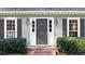 Close-up of a front entrance with black door, sidelights, and charming house number at 1903 Olde Village Run, Dunwoody, GA 30338