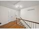 Hallway with hardwood floors, staircase and natural lighting at 1903 Olde Village Run, Dunwoody, GA 30338