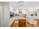Bright kitchen with granite countertops, wooden island and modern appliances at 1903 Olde Village Run, Dunwoody, GA 30338