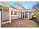 Brick patio leads to a screened-in porch of the home at 1903 Olde Village Run, Dunwoody, GA 30338