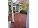 Brick patio leads to screened in porch with backyard view at 1903 Olde Village Run, Dunwoody, GA 30338