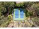 Aerial view of well-maintained community tennis courts surrounded by mature trees at 1903 Olde Village Run, Dunwoody, GA 30338