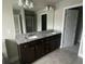 Bathroom with double vanity with granite countertop and tile flooring at 5021 Falcon Pt, Douglasville, GA 30135