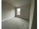 Bright bedroom with a large window and neutral carpet at 5021 Falcon Pt, Douglasville, GA 30135