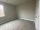 An empty bedroom with neutral walls, carpeted floors, and a bright window at 5021 Falcon Pt, Douglasville, GA 30135