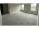 A very spacious bedroom with neutral walls and bright windows at 5021 Falcon Pt, Douglasville, GA 30135