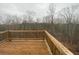 A wooden deck overlooks a serene wooded area, perfect for outdoor relaxation at 5021 Falcon Pt, Douglasville, GA 30135